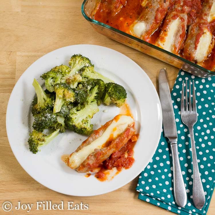 stuffed sausages served on a dinner plate with broccoli