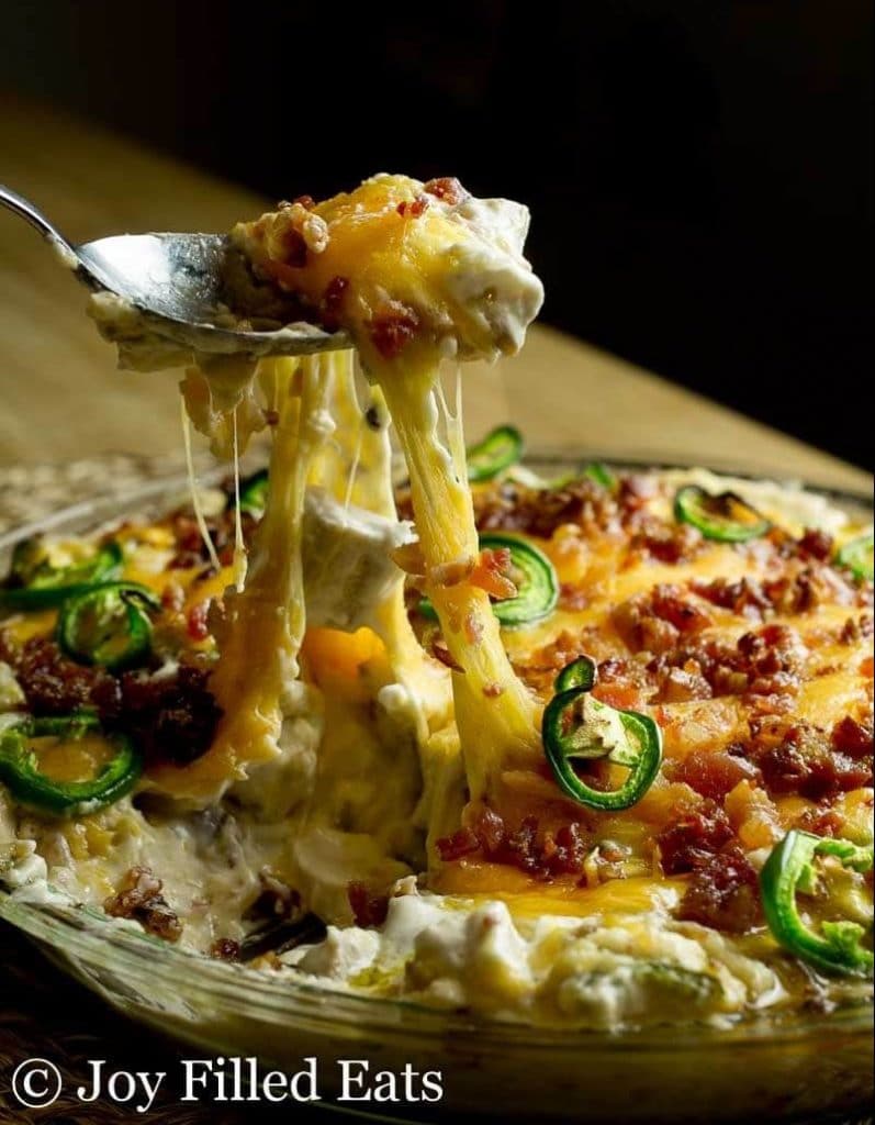 jalapeno popper dip scooped with a spoon