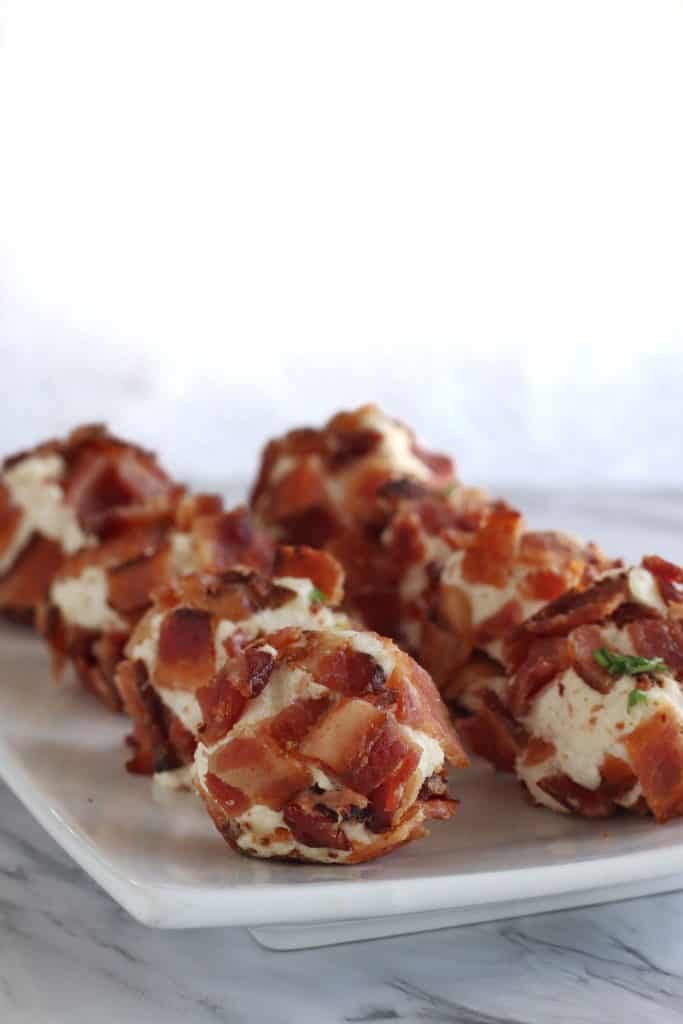 keto bacon crab rangoon fat bombs lined up on a plate