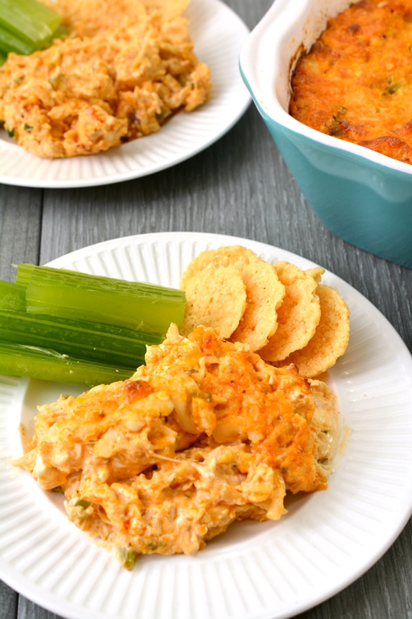 plate with keto buffalo chicken dip, celery, and cheese crisps