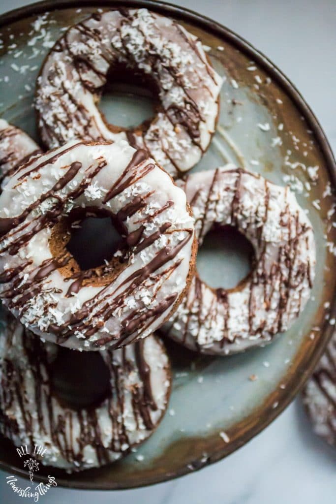 keto chocolate coconut donuts on a brown-rimmed plate