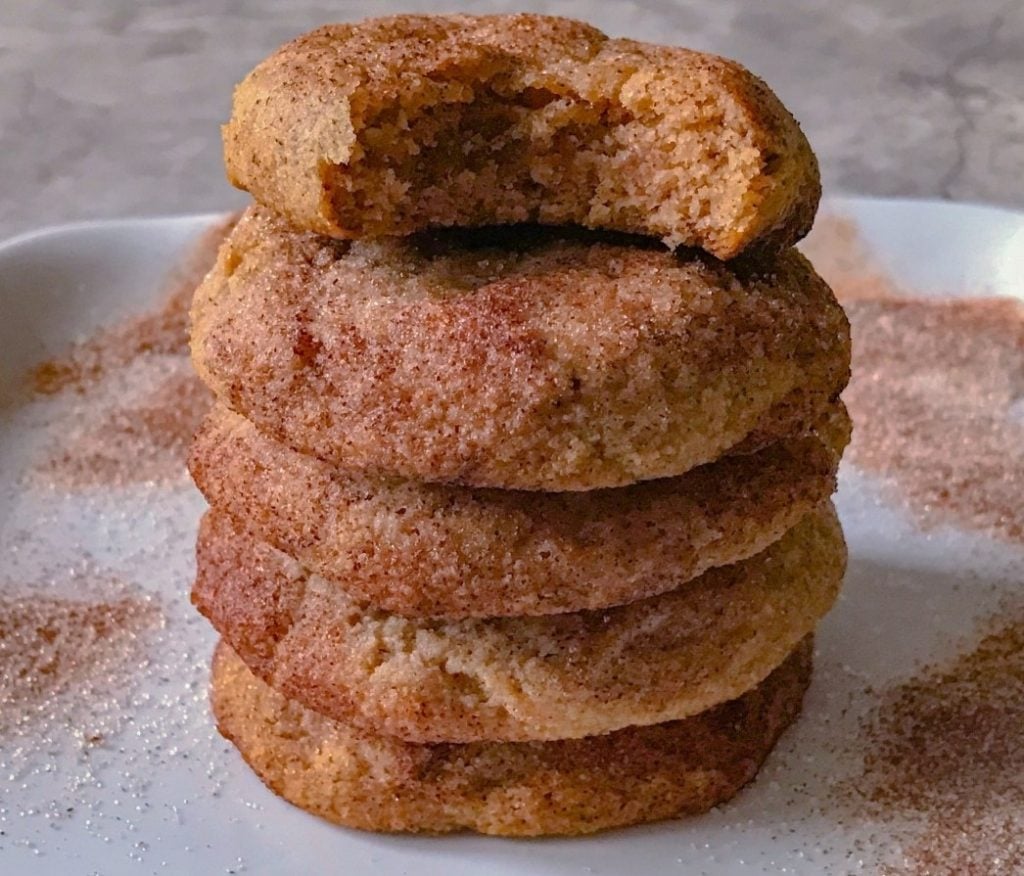 stack of 5 keto snickerdoodle cookies with one half-eaten