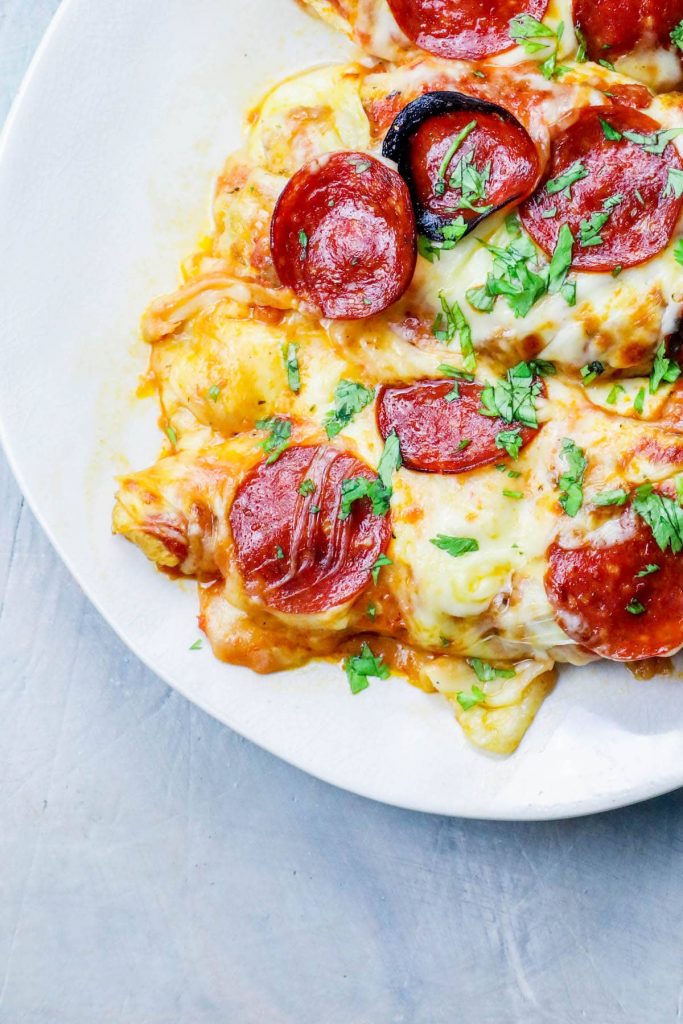 keto cheesy pizza chicken on a white dinner plate