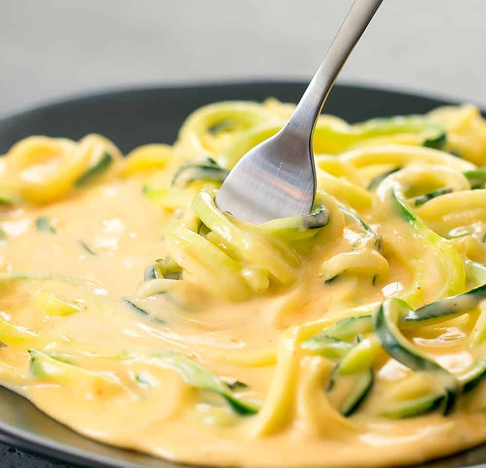 zucchini noodle mac and cheese with fork twirling noodles