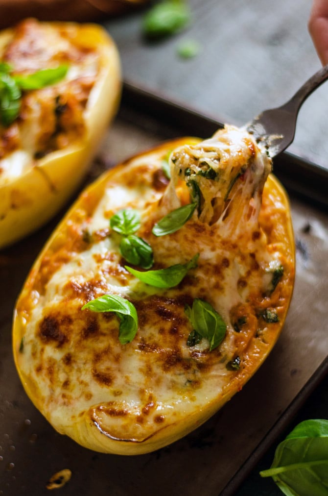 cheesy tuscan spaghetti squash with a fork taking out a bite