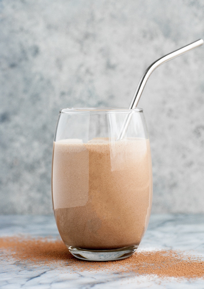 chocolate fat bomb smoothie in a glass with a stainless steel straw