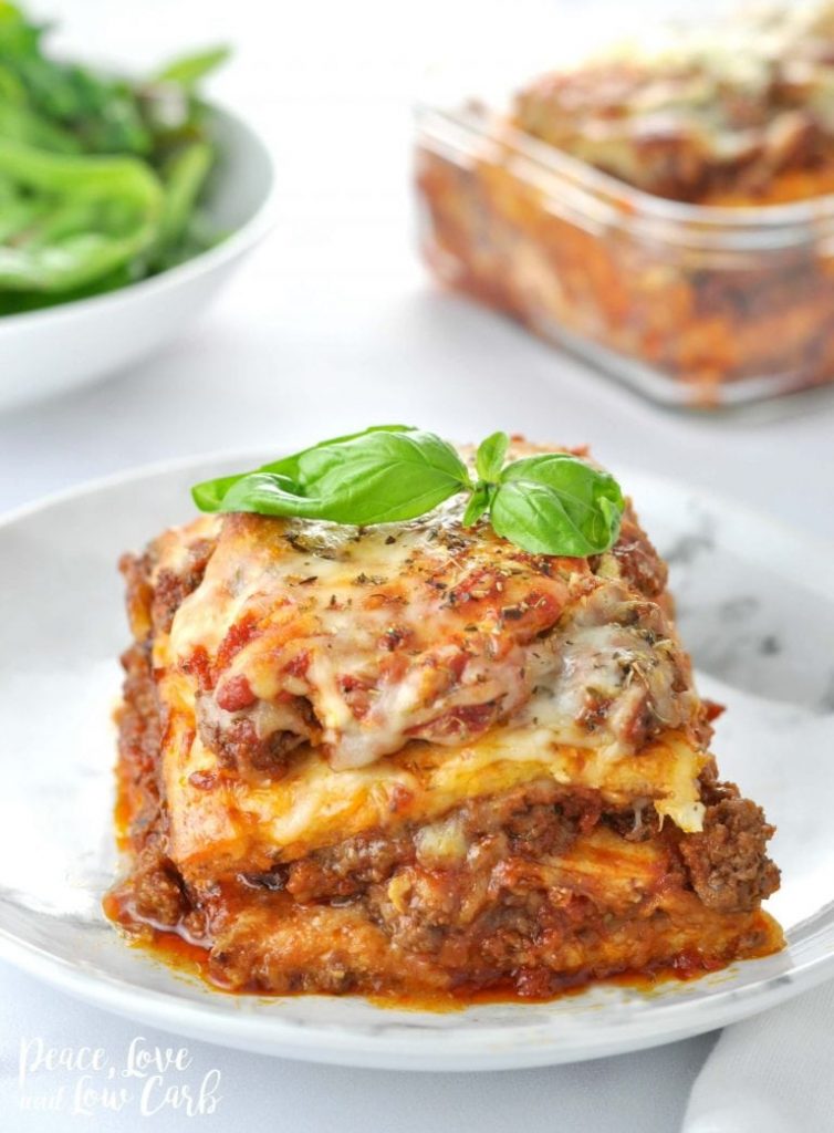 side view of one serving of low carb keto lasagna topped with basil