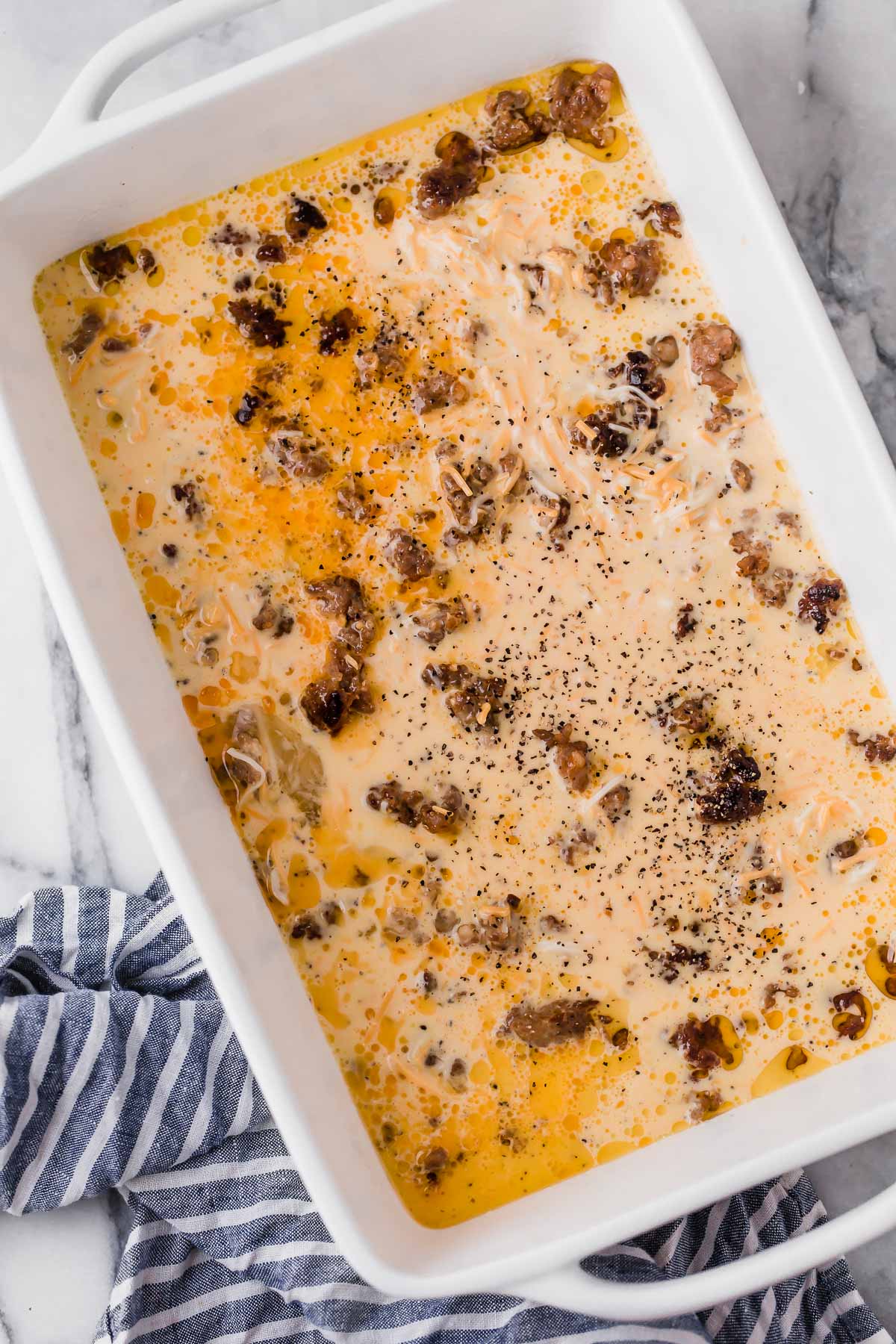 uncooked Low Carb Sausage Breakfast Casserole in a baking dish