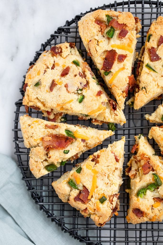 Baked Low-Carb Bacon Cheddar Jalapeño Scones on a cooling rack atop a marble kitchen counter