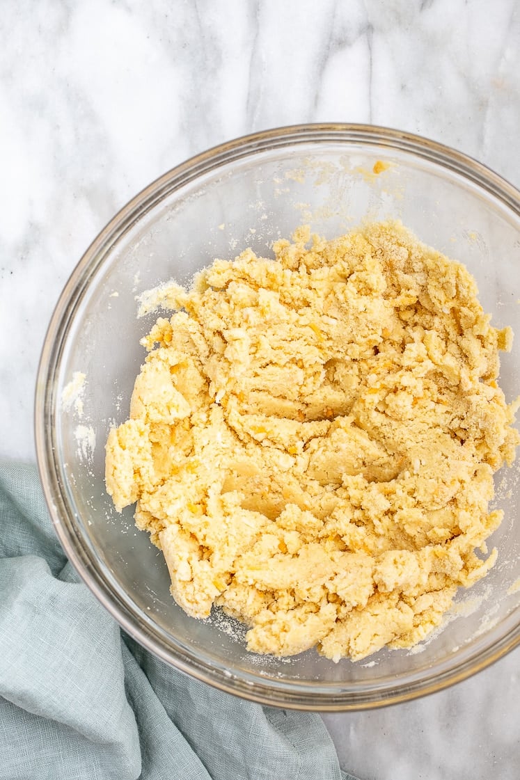 Low-Carb Cheddar Scone dough in a mixing bowl atop a marble kitchen counter