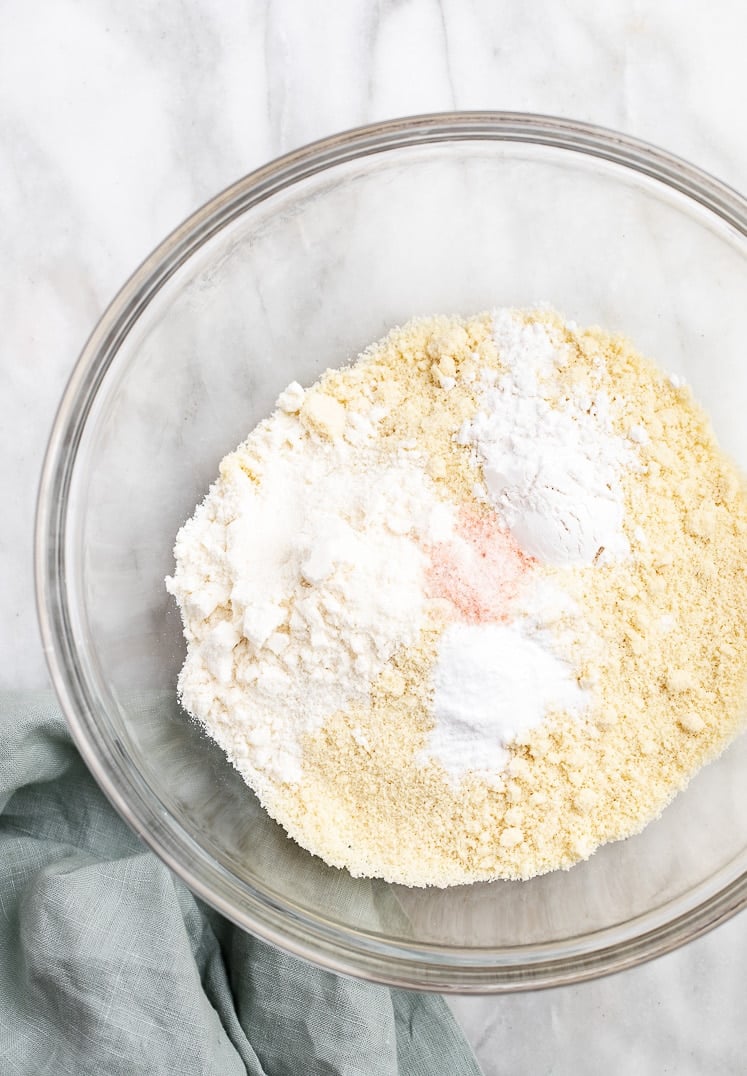 a large bowl with almond flour, coconut flour, baking soda, cream of tartar, and salt