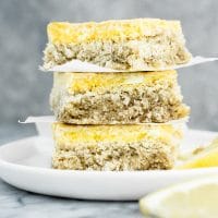 hero shot of keto lemon bars stacked on top of each other on a plate atop a marble kitchen counter