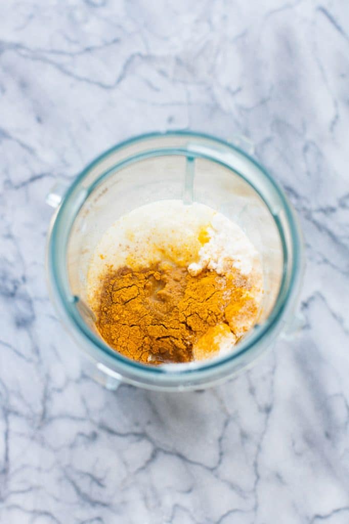 ingredients for golden keto smoothie in a tall food processor cup