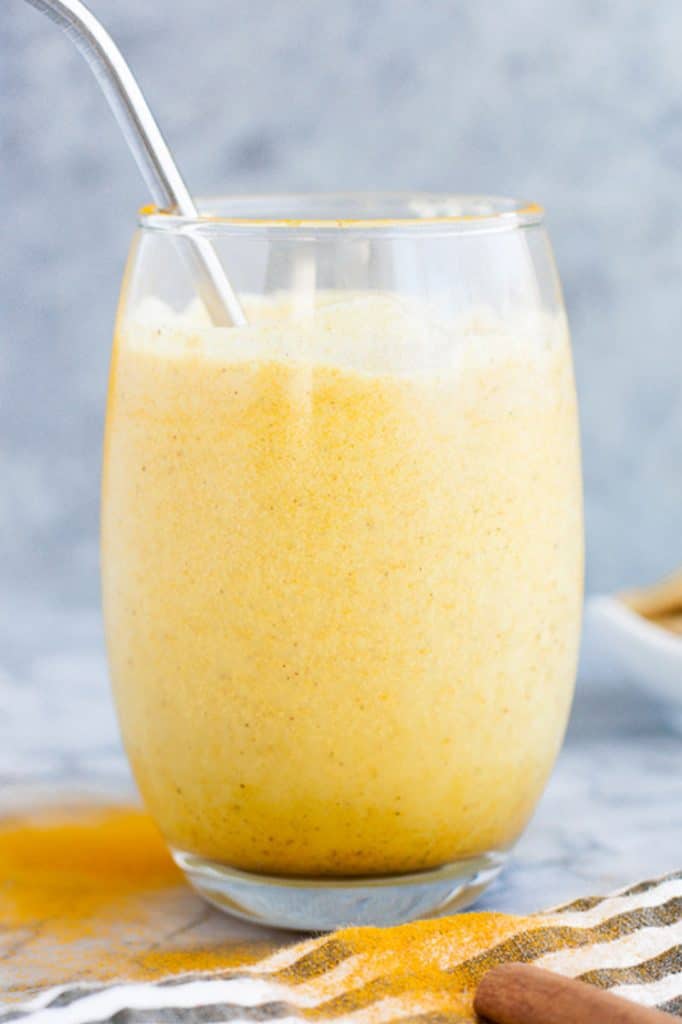 hero shot of a glass of Keto Golden Smoothie with a stainless steel straw