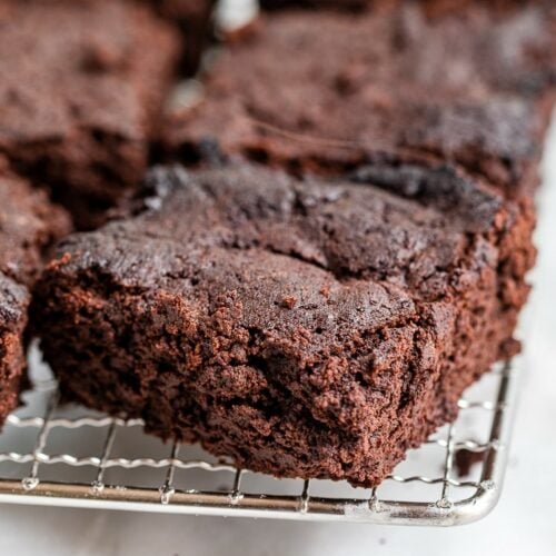 Keto Flourless Mocha Brownies on a cooling rack atop a marble kitchen counter