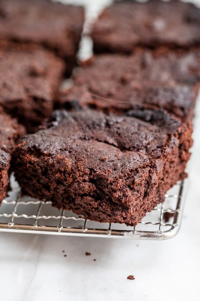 Keto Flourless Mocha Brownies on a cooling rack atop a marble kitchen counter