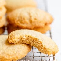 low carb cookies on a cooling rack with one bitten in half