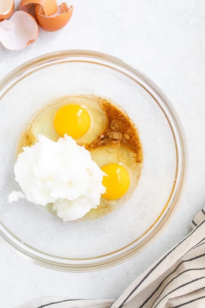 eggs, monk fruit sweetener, and coconut butter in a glass mixing bowl