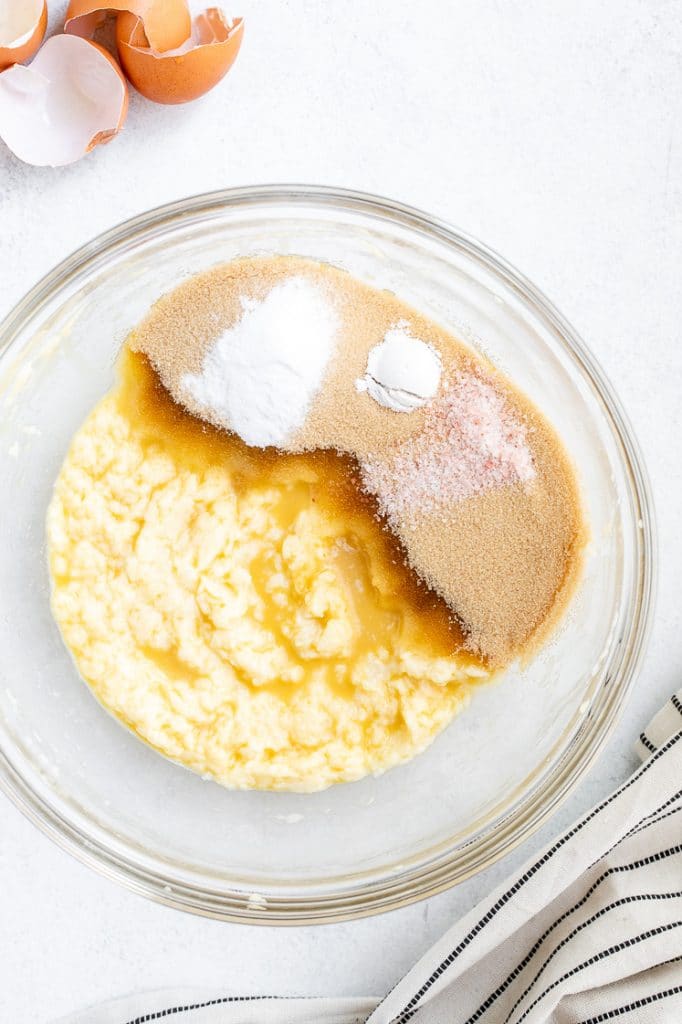 wet ingredients mixed through with sweetener in a glass mixing bowl