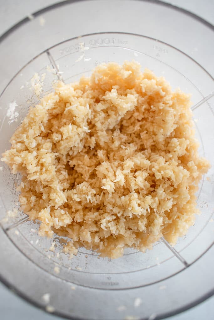combined maple syrup, coconut cream, coconut oil, and shredded coconut using a blender