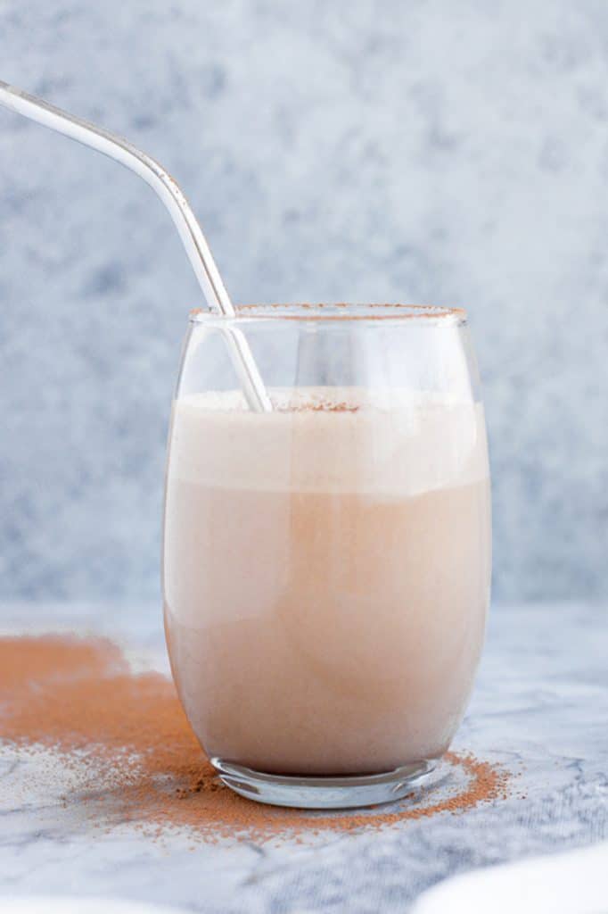 1 serving of keto mocha smoothie - a glass full with stainless steel drinking straw