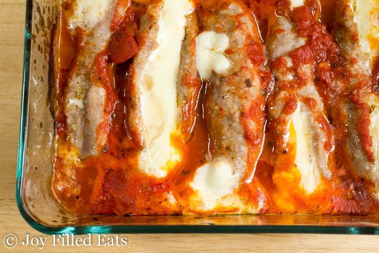 stuffed Italian sausages in a glass baking dish 