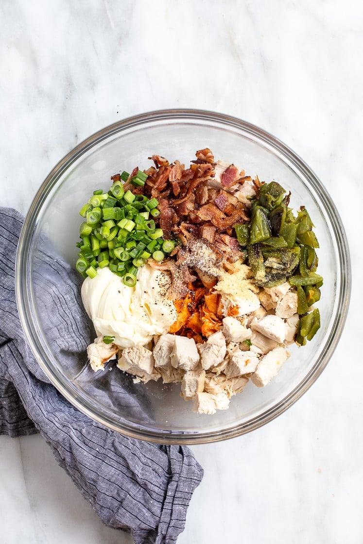 unmixed ingredients for jalapeno popper chicken salad in a glass mixing bowl