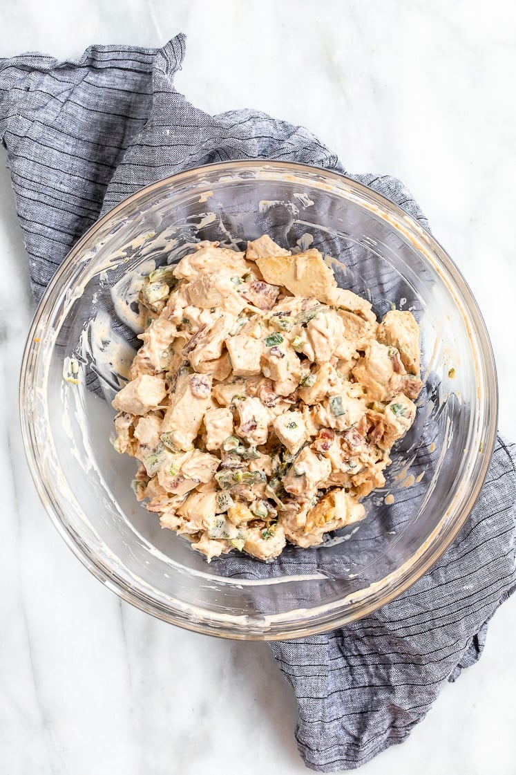 a big glass mixing bowl of jalapeno popper chicken salad