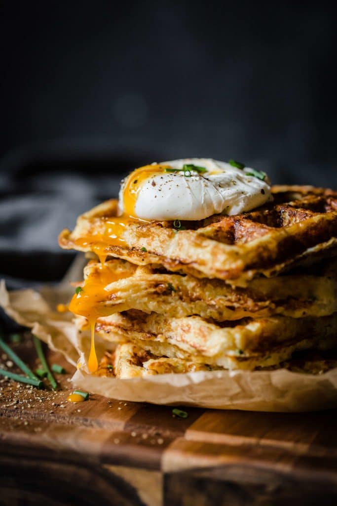 Stack of Ham and Gruyere Cauliflower rice waffles with a poached egg on top