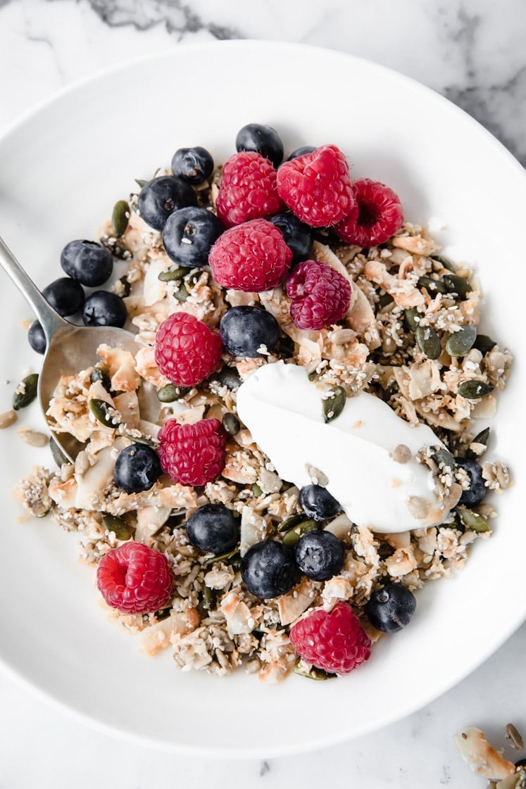 featured recipe image Nut Free Keto Cereal in a bowl with raspberries and blueberries