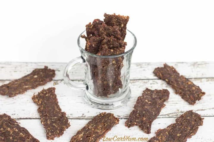 spicy low carb ground beef jerky in a clear glass mug