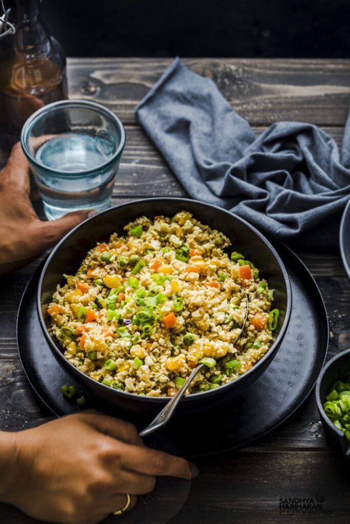 healthy cauliflower rice in a black bowl