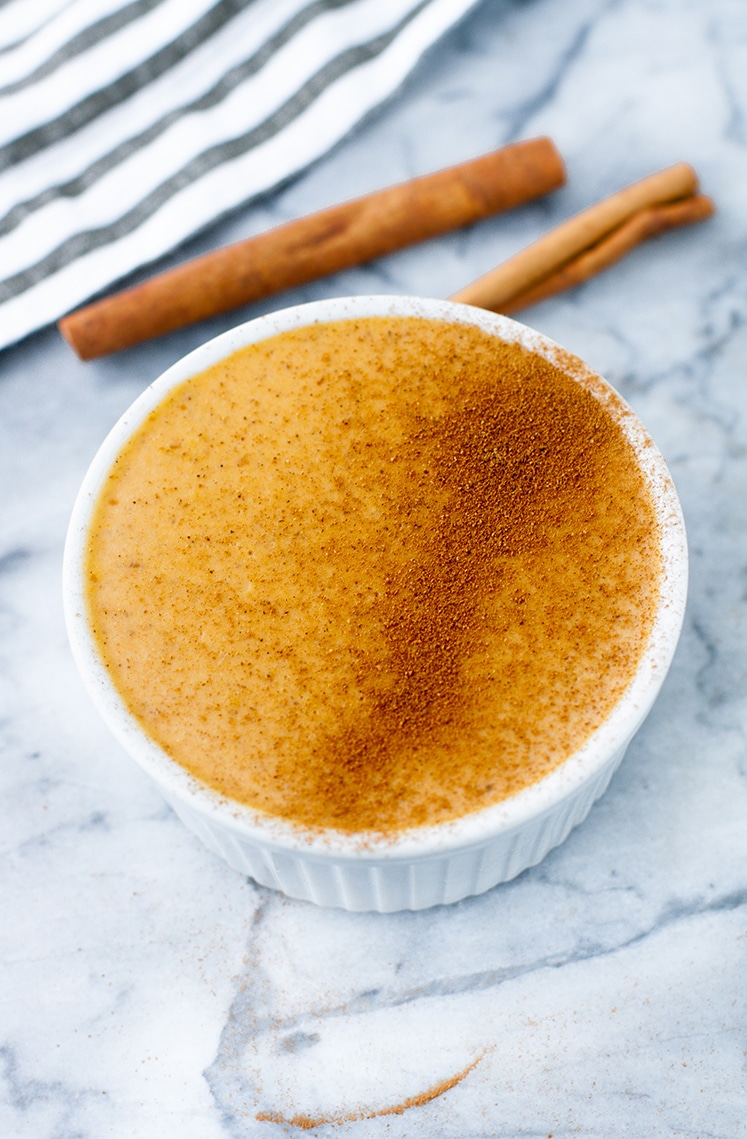 close-up shot of Pumpkin Pie Panna Cotta sprinkled with cinnamon on top