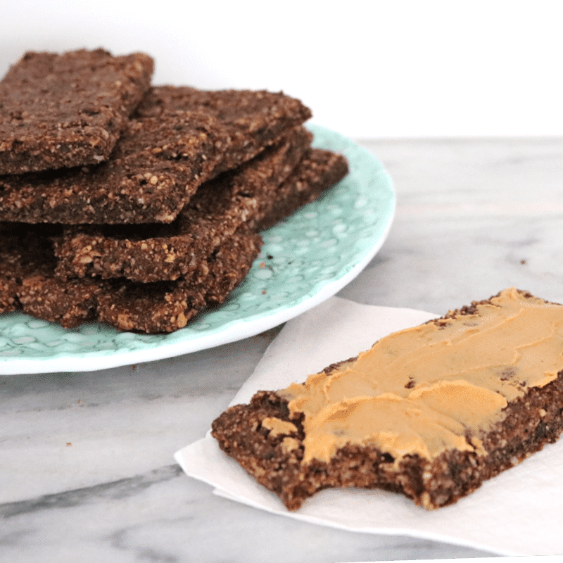 chocolate vegan protein bars on a plate atop a marble kitchen counter