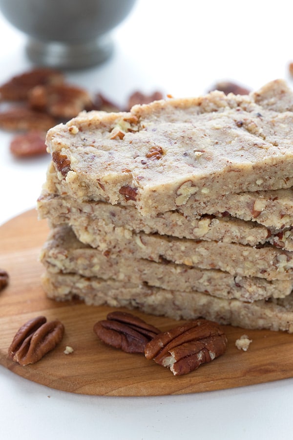 6 pecan pie energy bars stacked on top of each other atop a marble kitchen counter