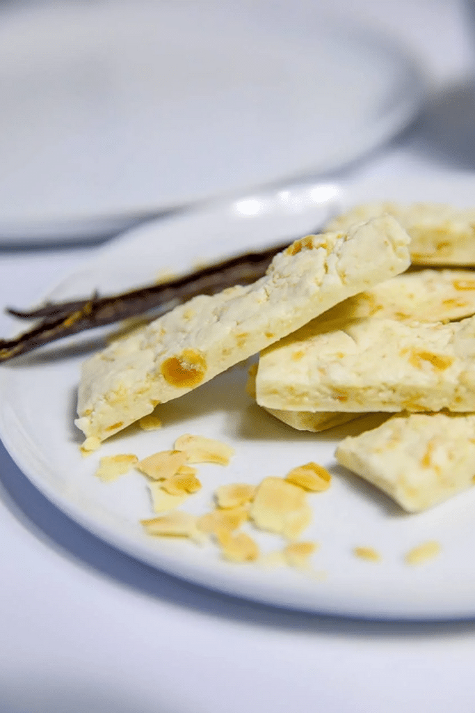 a stack of vanilla nougat protein bars on a small plate atop a marble kitchen counter