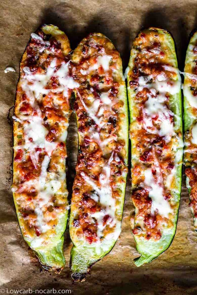 overhead shot of 3 zucchini boats on a parchment paper