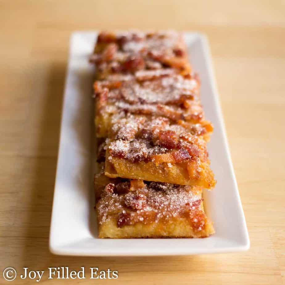 a plate of maple bacon crack atop a wooden table