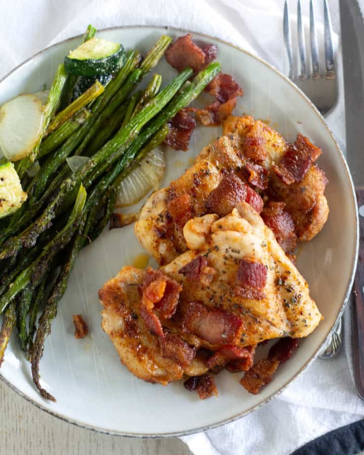 One-Skilletketo chicken with bacon on a plate with roasted asparagus