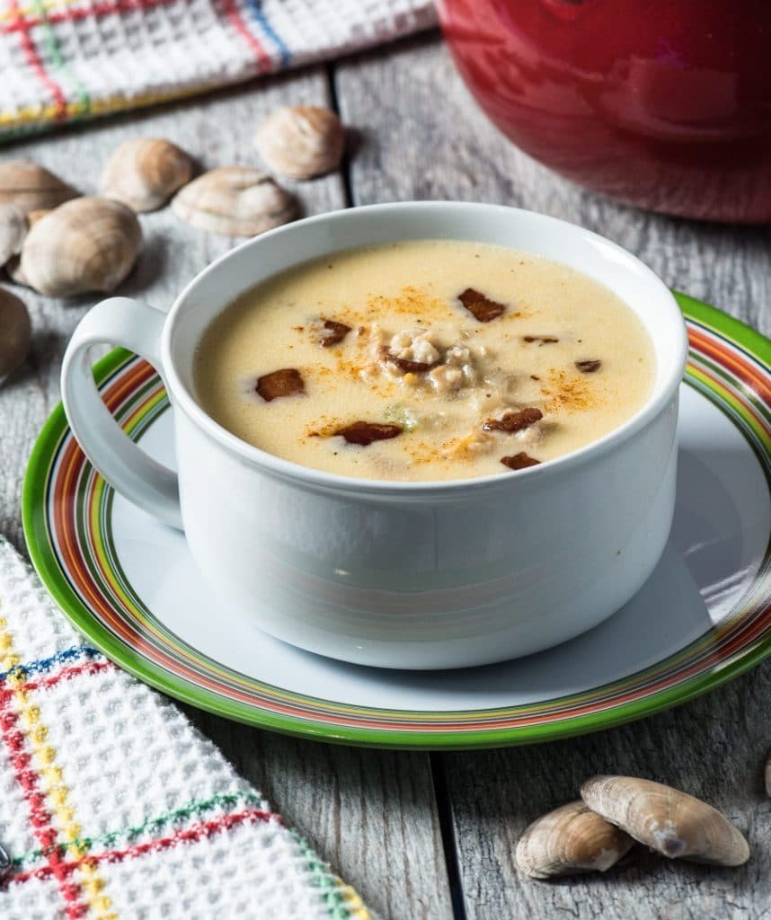 one bowl of keto clam chowder atop a wooden table