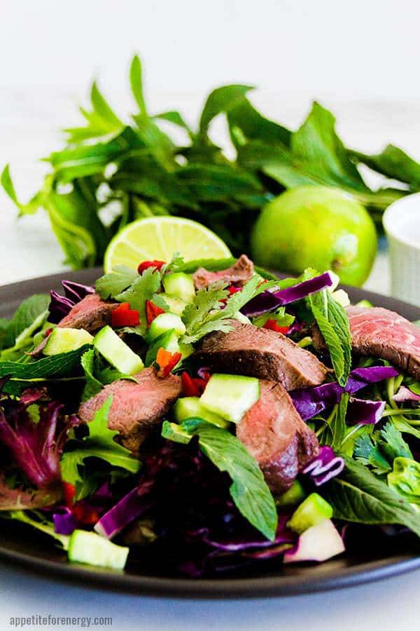 close-up shot of low carb thai beef on a plate atop a wooden table