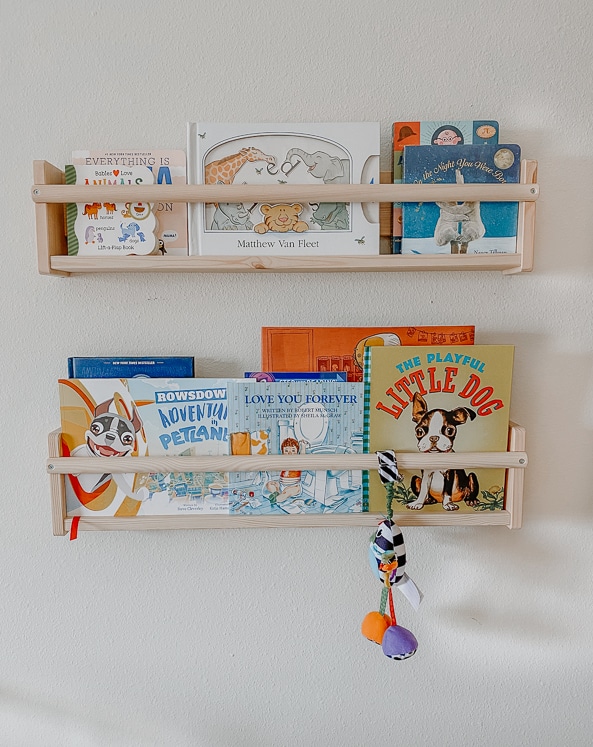 wooden bookshelves with baby books for gender neutral baby nursery