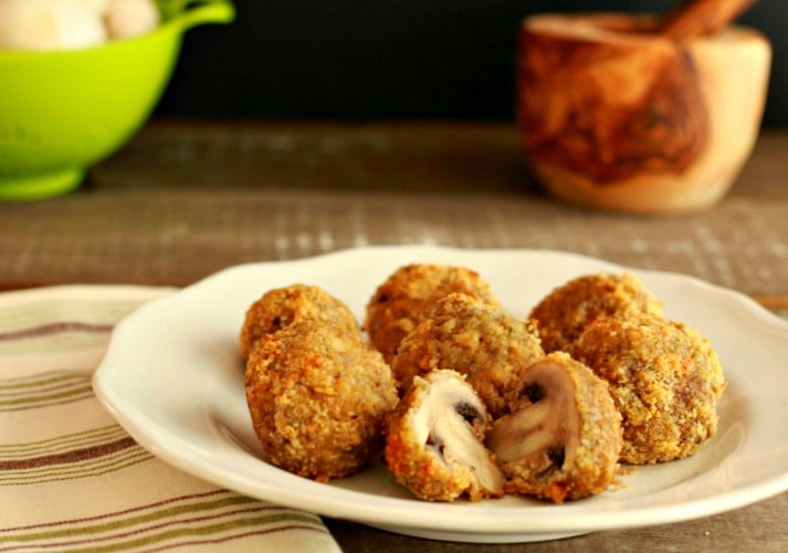 oven fried garlic mushroom on a plate atop a wooden table