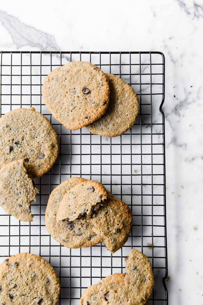 nut-free keto chocolate cookies resting on a wire rack atop a marble kitchen table