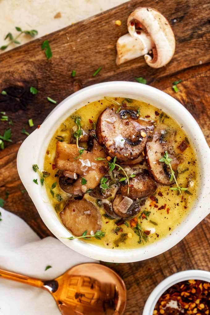 overhead shot of a bowl of keto mushroom soup atop a wooden table