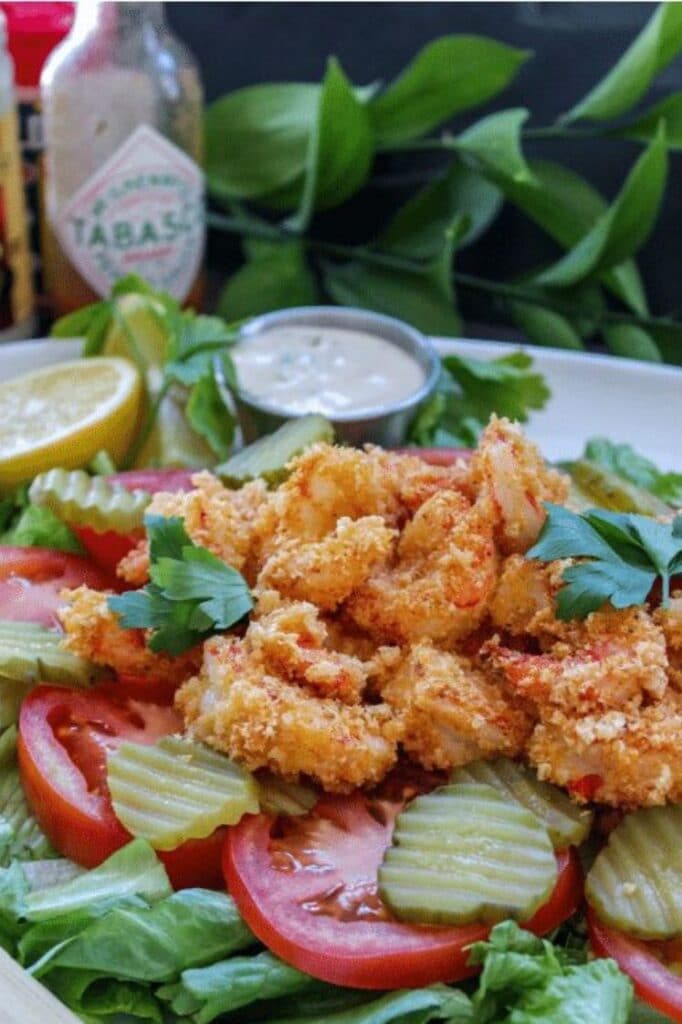 low carb shrimp po' boy salad on a plate atop a kitchen counter