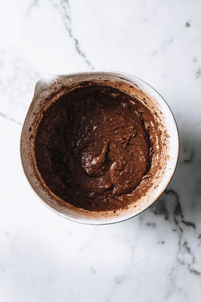 keto chocolate sea salt cookie mixture in a bowl atop a marble kitchen counter