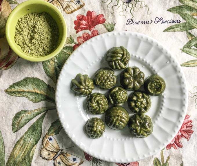 low carb mint matcha coconut candy on a plate atop a table