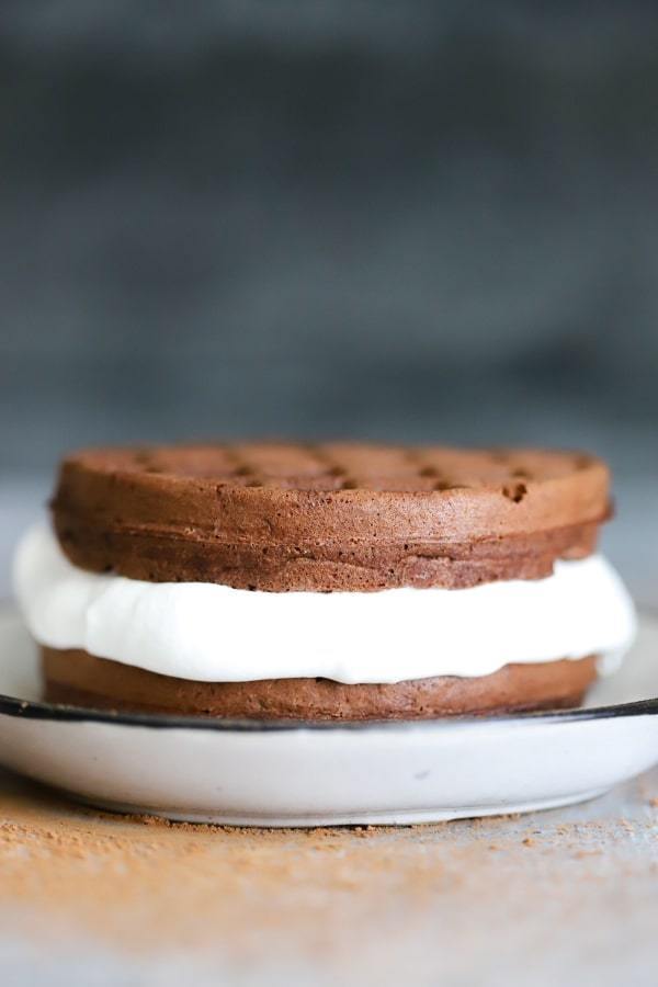 close-up image of oreo keto chaffle on a plate atop a wooden table