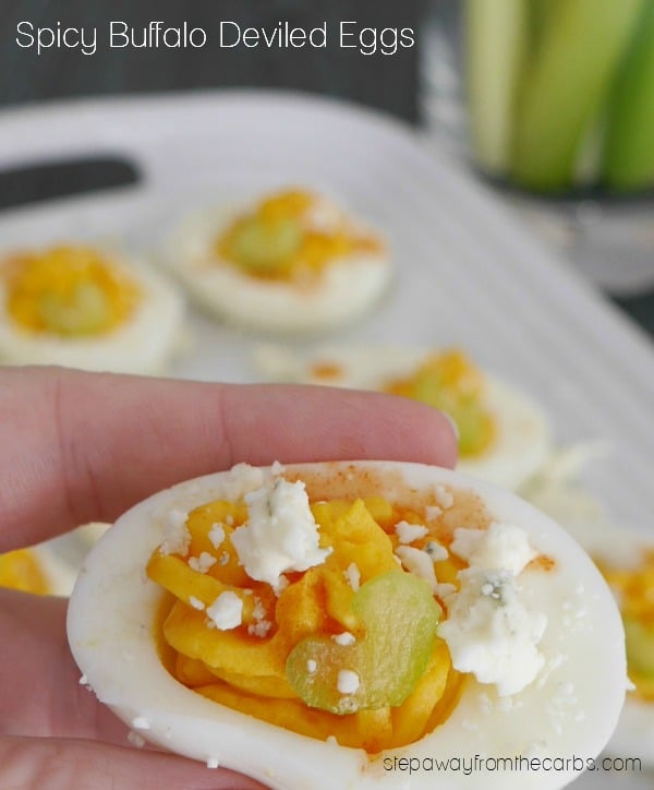 close-up shot of spicy buffalo deviled eggs being picked up